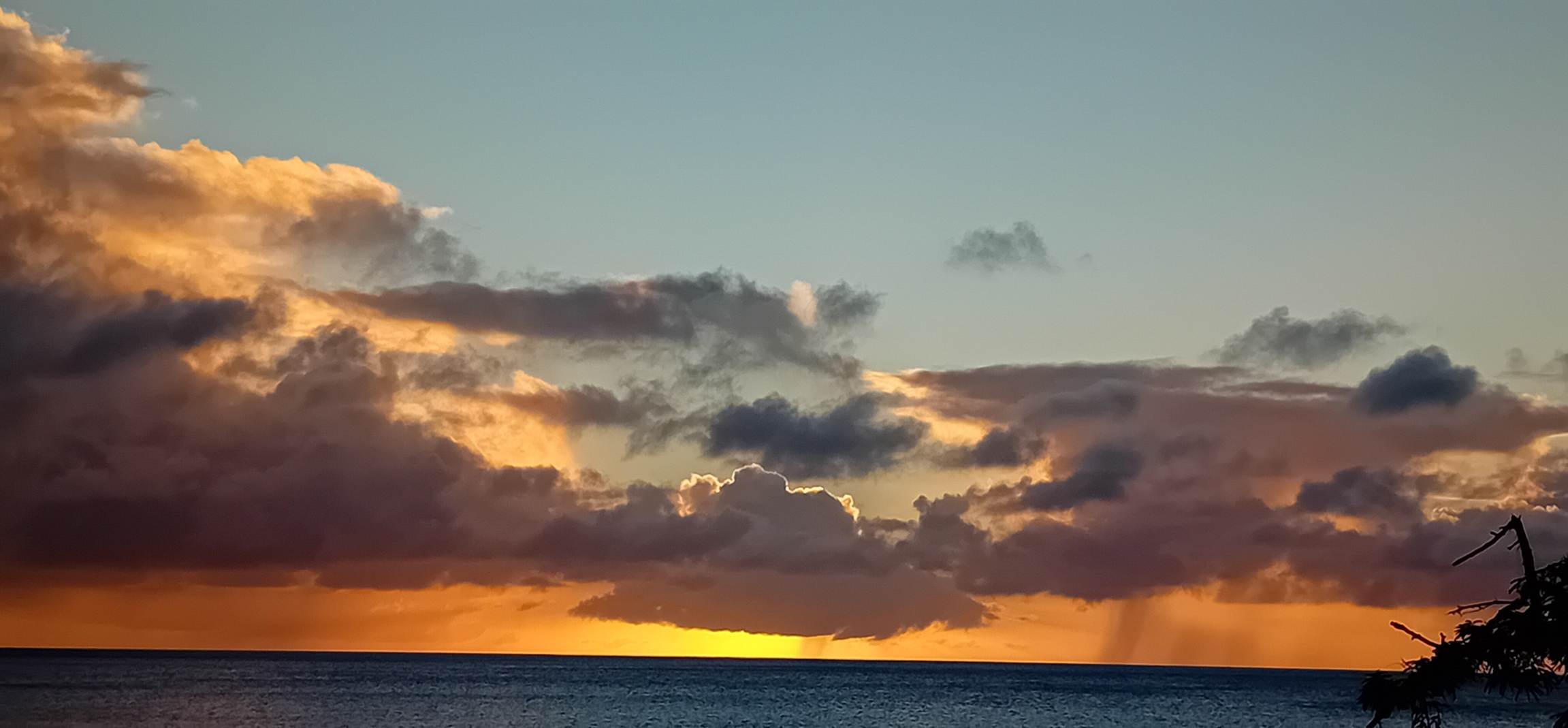 A sunset over water with clouds

AI-generated content may be incorrect.